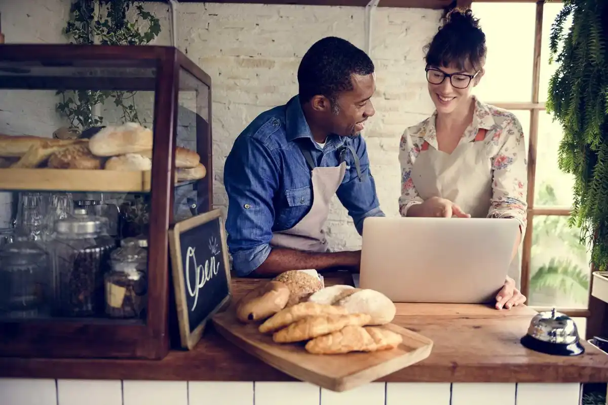 People working at the cashier of a bakery
